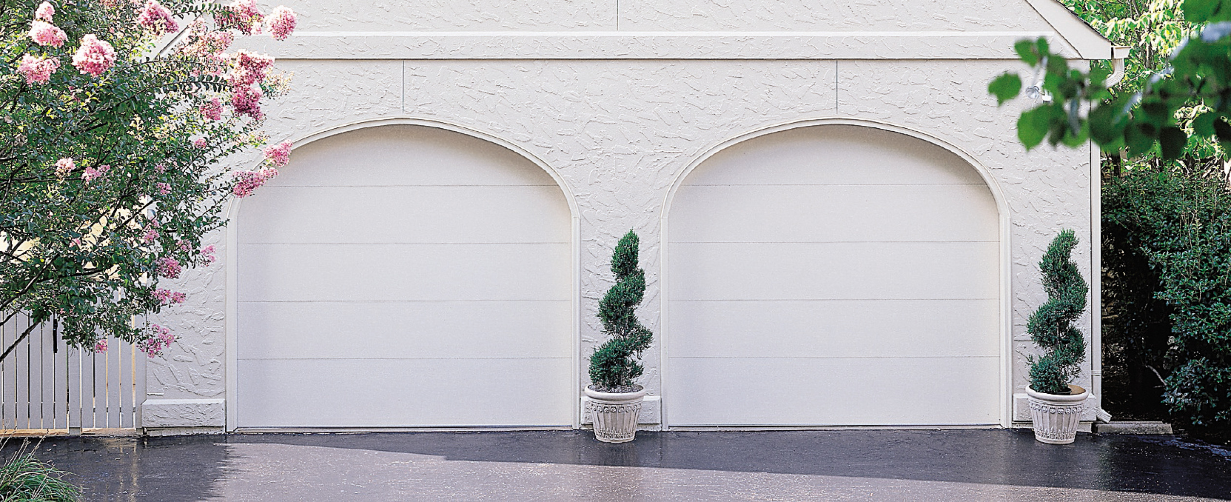 Clean and elegant, a flush panel door in True White elevates any exterior