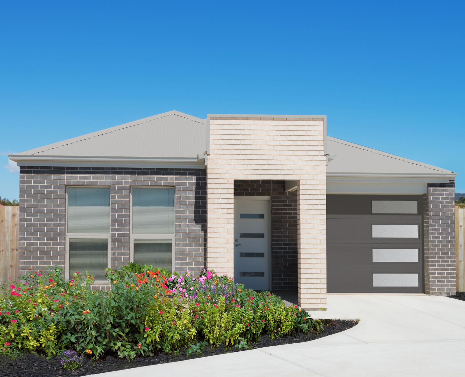 A flush panel garage door with mosaic windows brings simple lines to match the style of the front door